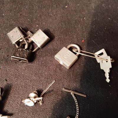 TIE TACKS AND CLIPS, SQUARE NAILS, BUSH CO RODEO TOKEN, CUFFLINKS AND SMALL PADLOCKS