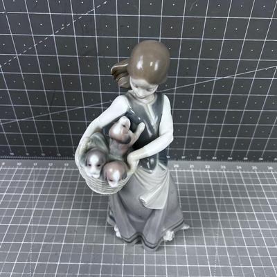 Lladro #1311   Titled: Girl with Basket of Puppies 