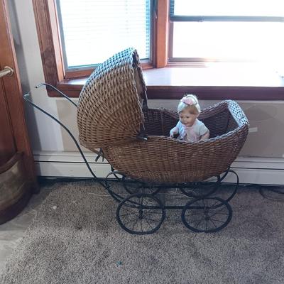 ANTIQUE WICKER BABY BUGGY WITH PORCELAIN BABY DOLL