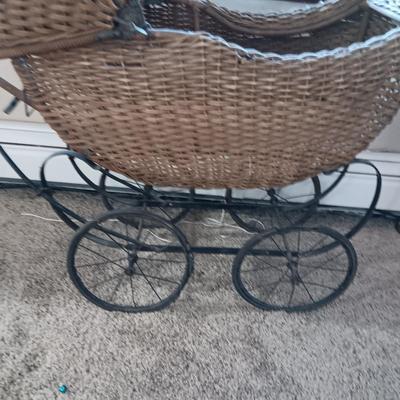 ANTIQUE WICKER BABY BUGGY WITH PORCELAIN BABY DOLL