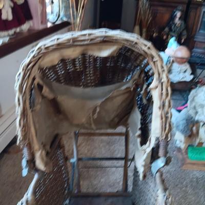 ANTIQUE WICKER BABY BUGGY WITH PORCELAIN BABY DOLL