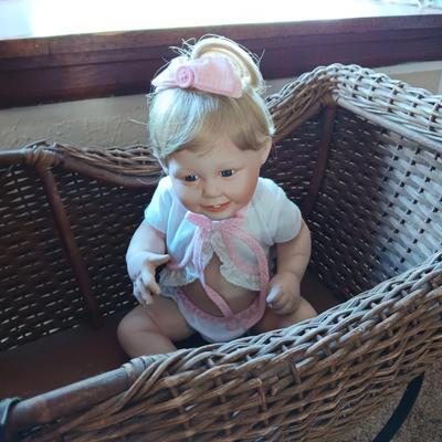 ANTIQUE WICKER BABY BUGGY WITH PORCELAIN BABY DOLL