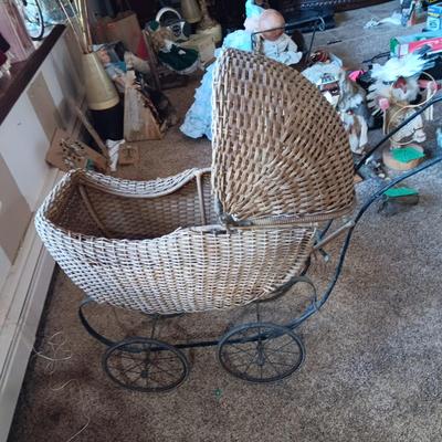 ANTIQUE WICKER BABY BUGGY WITH PORCELAIN BABY DOLL
