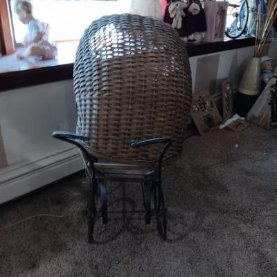ANTIQUE WICKER BABY BUGGY WITH PORCELAIN BABY DOLL
