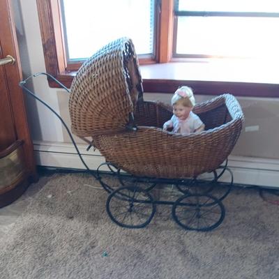 ANTIQUE WICKER BABY BUGGY WITH PORCELAIN BABY DOLL