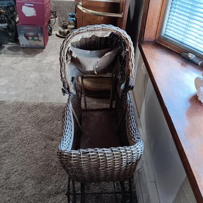 ANTIQUE WICKER BABY BUGGY WITH PORCELAIN BABY DOLL