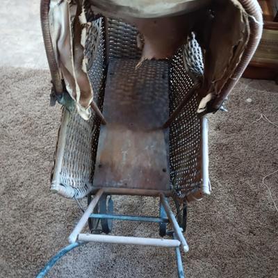 ANTIQUE WICKER BABY BUGGY WITH PORCELAIN BABY DOLL