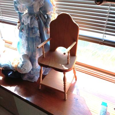 2 SWEET PORCELAIN DOLLS AND A WOODEN DOLL CHAIR