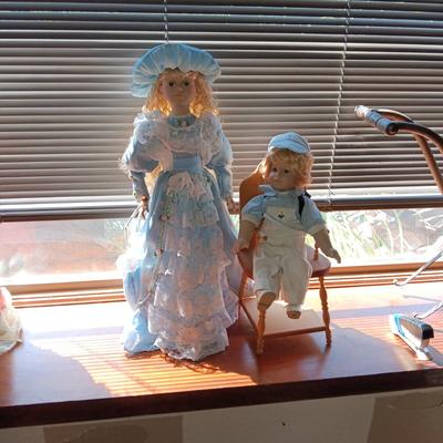 2 SWEET PORCELAIN DOLLS AND A WOODEN DOLL CHAIR