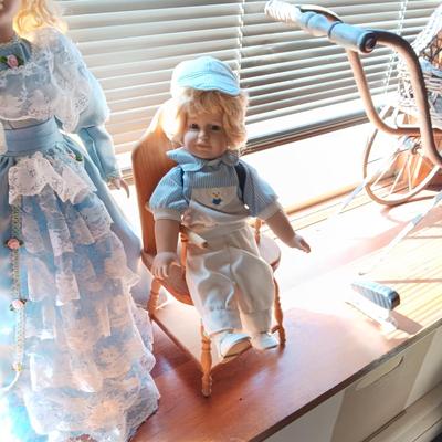 2 SWEET PORCELAIN DOLLS AND A WOODEN DOLL CHAIR