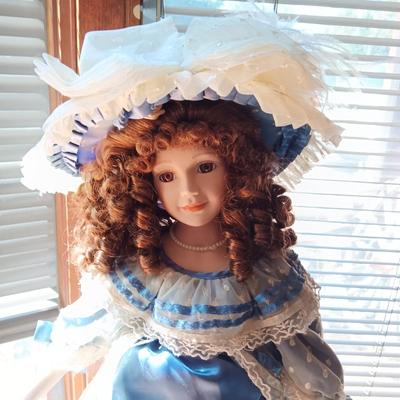 2 PRETTY PORCELAIN DOLLS AND A WOODEN DOLL CHAIR