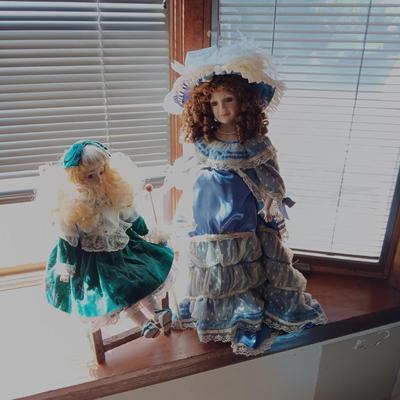 2 PRETTY PORCELAIN DOLLS AND A WOODEN DOLL CHAIR