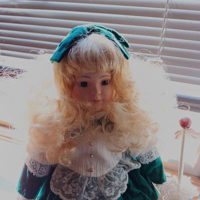 2 PRETTY PORCELAIN DOLLS AND A WOODEN DOLL CHAIR