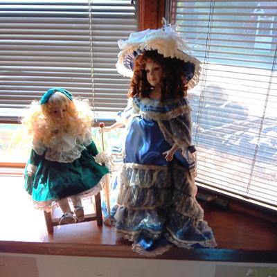 2 PRETTY PORCELAIN DOLLS AND A WOODEN DOLL CHAIR