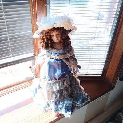 2 PRETTY PORCELAIN DOLLS AND A WOODEN DOLL CHAIR