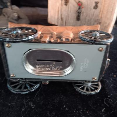 RED DOG SALOON STATUE, METAL COVERED WAGON COIN BANK AND OUTHOUSE CLOCK