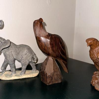2 CARVED WOODEN FALCONS, A LEOPARD AND ELEPHANT STATUES