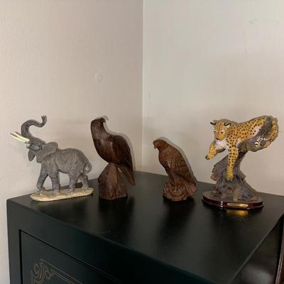 2 CARVED WOODEN FALCONS, A LEOPARD AND ELEPHANT STATUES