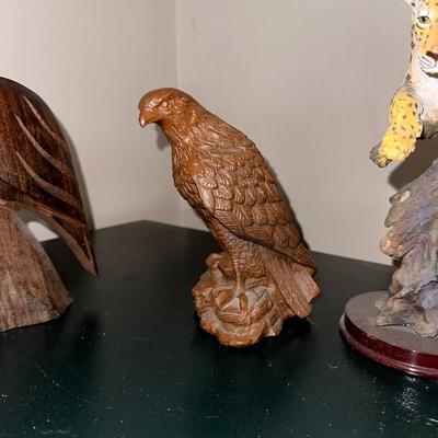 2 CARVED WOODEN FALCONS, A LEOPARD AND ELEPHANT STATUES