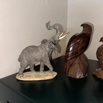 2 CARVED WOODEN FALCONS, A LEOPARD AND ELEPHANT STATUES