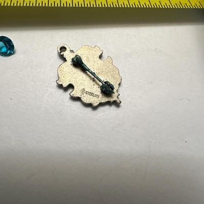 A 925 ring, loose stone, and choir pin