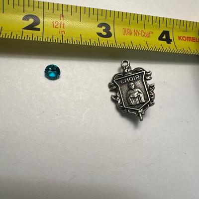 A 925 ring, loose stone, and choir pin