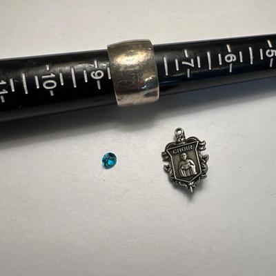 A 925 ring, loose stone, and choir pin