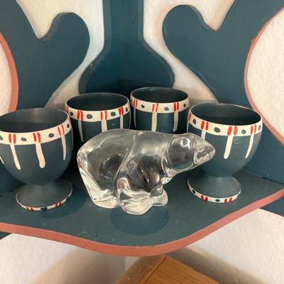Corner shelf with carved man, egg cups, Crystal, bear and thermometer