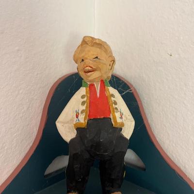 Corner shelf with carved man, egg cups, Crystal, bear and thermometer