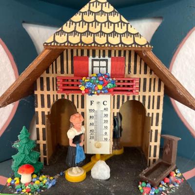 Corner shelf with carved man, egg cups, Crystal, bear and thermometer