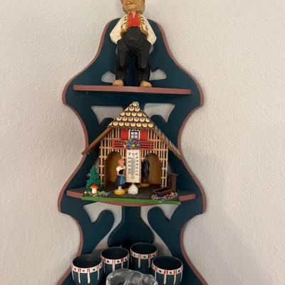 Corner shelf with carved man, egg cups, Crystal, bear and thermometer