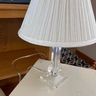 Bookshelf, white side table, lucite lamp, books