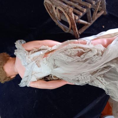 VINTAGE DOLL AND A CHAIR MADE OF TWIGS