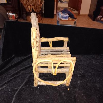 VINTAGE DOLL AND A CHAIR MADE OF TWIGS