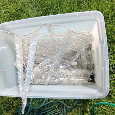ROPE LIGHTS, OUTDOOR EXTENSION CORDS AND ICICLE LIGHTS ALL IN A STORAGE TOTE