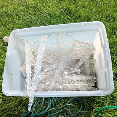 ROPE LIGHTS, OUTDOOR EXTENSION CORDS AND ICICLE LIGHTS ALL IN A STORAGE TOTE