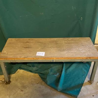 Metal Table with Wheels on one end.