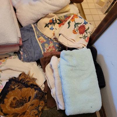 Assortment of towels, two hot water bags, shower curtain, hair clips