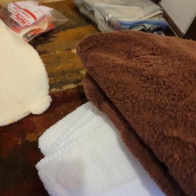 Assortment of towels, two hot water bags, shower curtain, hair clips