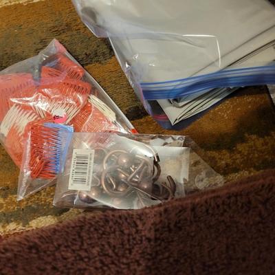 Assortment of towels, two hot water bags, shower curtain, hair clips