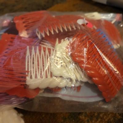 Assortment of towels, two hot water bags, shower curtain, hair clips