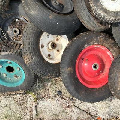 A PILE OF SMALL TIRES (WHEELBARROW, DOLLY, ETC)