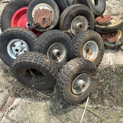 A PILE OF SMALL TIRES (WHEELBARROW, DOLLY, ETC)