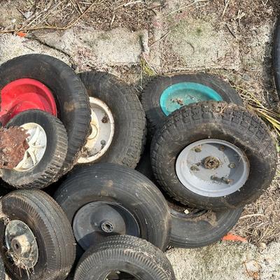 A PILE OF SMALL TIRES (WHEELBARROW, DOLLY, ETC)