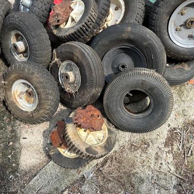 A PILE OF SMALL TIRES (WHEELBARROW, DOLLY, ETC)