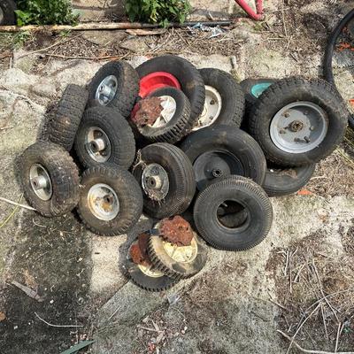 A PILE OF SMALL TIRES (WHEELBARROW, DOLLY, ETC)