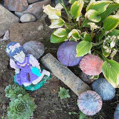 CONCRETE MUSHROOMS AND A LITTLE GIRL YARD ART