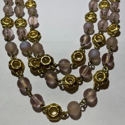 Vintage Preowned Gold-tone Triple Strand Pinkish Glass Bead Fashion Necklace 16-19" Adjustable in Very Good Preowned Condition.