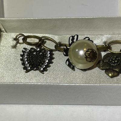 Vintage Mid-Century Antiqued Brass Charm Bracelet by Decade with Miscellaneous Charms as Pictured.