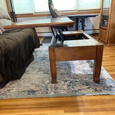 LIFT COFFEE TABLE WITH SOME LOSS OF FINISH TO THE TOP